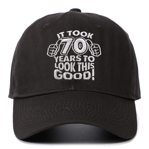 Detailed close-up of white embroidery on a black 70th birthday cotton baseball cap