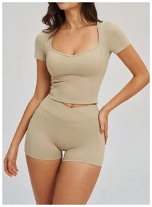 Detail of high-waist yoga shorts with cross waistband and side pockets for sports