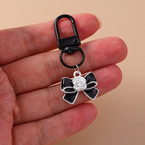 Trendy black ribbon keychain with white rose detail and secure black metal hook