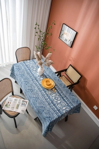 Detailed top view of blue and white geometric cotton linen tablecloth on rectangular table