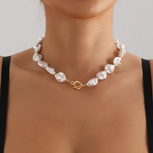 Detail of baroque freshwater pearl necklace featuring a vintage golden OT toggle clasp