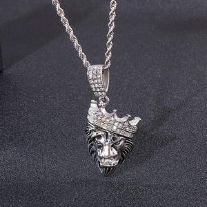 Detailed close-up of a silver lion head pendant with iced-out crown on a twisted rope chain