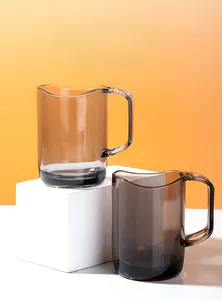 Detail of translucent smoke brown cups with elegant wavy edges and ergonomic handles