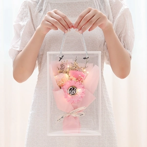 Pink soap roses and sunflower bouquet with LED lights in a transparent gift bag
