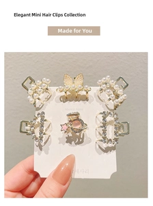 Close-up of 6-piece mini gold hair clips set with pearls and sparkling rhinestones