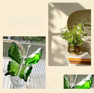 Detail of green crystal butterfly ornament with faceted wings on a clear crystal base