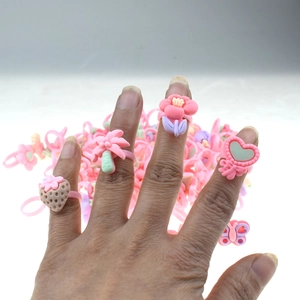 Close-up of colorful cartoon plastic rings featuring strawberry and flower designs