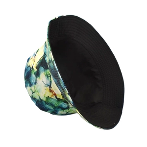 Detailed side view of a colorful double-sided bucket hat with abstract ink print and black lining