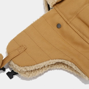 Detailed close-up of khaki winter trapper hat with soft fleece lining and buckle strap