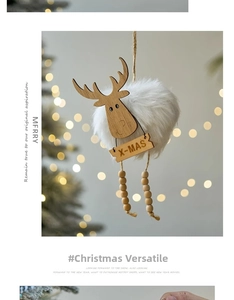 Detail of wooden reindeer ornament with white plush body and X-MAS tag on Christmas tree