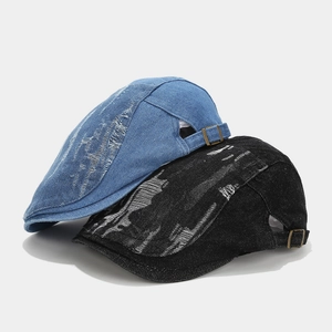 Vintage washed denim beret cap with distressed ripped details and adjustable metal buckle