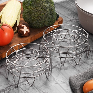 Support de cuisson vapeur rond en acier inoxydable posé sur un plan de travail en marbre
