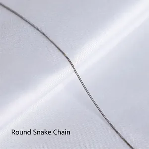 Close-up of polished silver round snake chain necklace with dense flexible texture