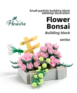 Detail of pink succulent building blocks set with a small flowerpot and labeled marker