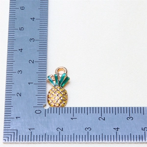 Miniature yellow pineapple fruit pendant with green leaves and gold alloy frame detail