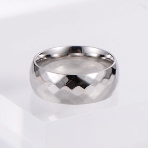 Minimalist silver Mobius ring with diamond-cut pattern on polished stainless steel
