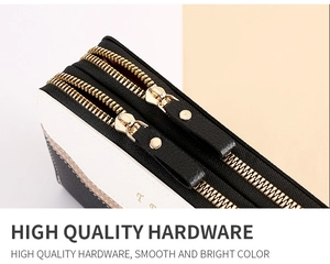 Detail view of smooth double zippers with high-quality gold metal hardware on color block wallet