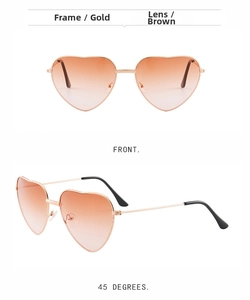 Detail of heart-shaped sunglasses with gold metal frame and brown gradient lenses