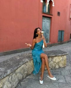 Detail of blue one-shoulder maxi dress with snakeskin texture and high side slit
