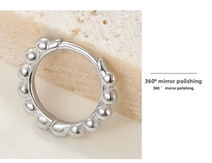 Macro view of sterling silver hoop earrings with 360-degree mirror polished finish
