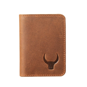 Close-up of vintage brown leather card holder featuring a debossed bull head and stitching