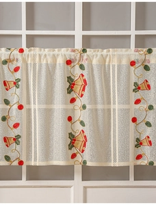 Detailed view of Christmas bells and holly embroidery on cream white lace curtain valance