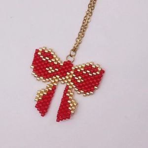 Handmade Miyuki bead bow pendant necklace with red and gold glass beads on a thin chain