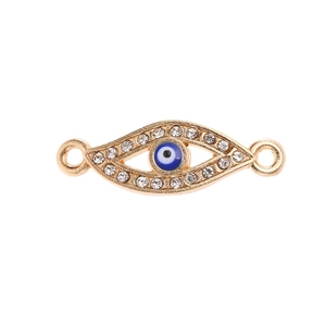 Macro view of gold evil eye pendant connector with blue stones and white crystals