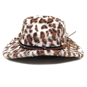 Detail of leopard print faux fur hat with brown leather strap and soft fluffy texture
