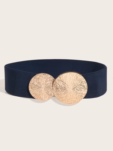 Detailed close-up of a wide navy blue elastic belt with a textured gold round metal buckle