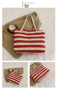 Detail of rose red and white striped straw tote bag showing rope handles and woven texture
