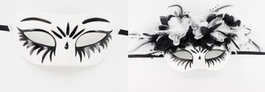 Detail of Day of the Dead masks with luxury feathers, lace, and floral decorations