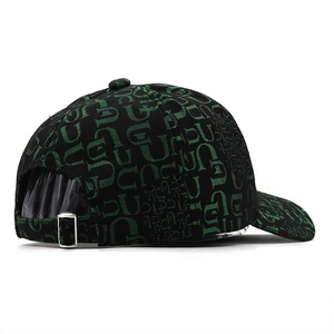 Detail of black baseball cap featuring green letter print and metal adjustable buckle