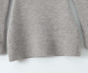 Detail view of the rib-knit texture and soft grey fabric of the long sleeve mini dress