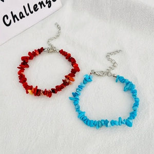 Detail view of red and blue natural stone beaded bracelets with adjustable metal chains