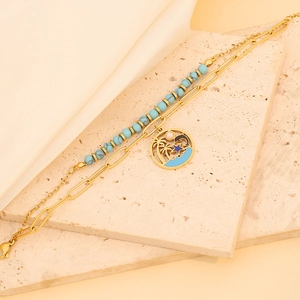Double-layer stainless steel bracelet featuring turquoise beads and beach themed pendants
