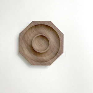 Top view of octagonal walnut wood tray with nested round grooves for jewelry display