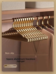 Detail of golden aviation aluminum hanger featuring non-slip wide shoulder and wave design