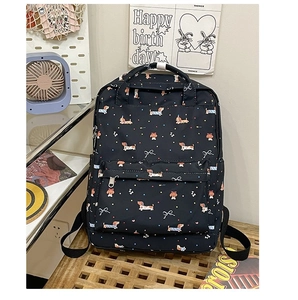 Detailed close-up of dark blue nylon backpack with cute cartoon dog and bow prints