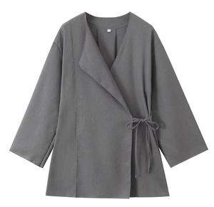 Flat lay detail of grey linen kimono jacket with waist tie design and size label