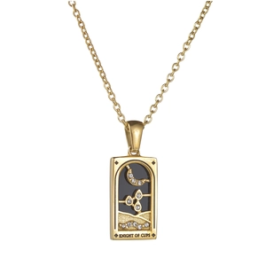 Macro shot of Knight of Cups tarot necklace featuring black enamel and sparkling zircons