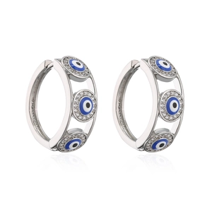 Silver evil eye hoop earrings with blue and white zircon stones on a white background