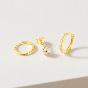 Macro detail of S925 sterling silver gold earring set with zircon stones and S925 hallmark