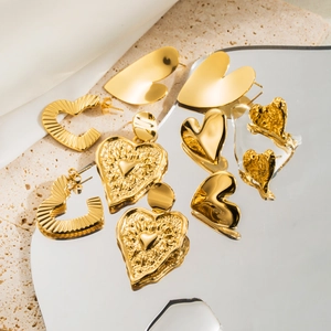 Macro shot of assorted golden heart earrings with polished and textured metal finishes