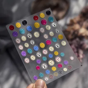 Macro detail of to 567 3D embossed emoji nail art stickers with colorful smiley faces