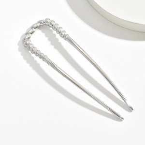 Close-up of a silver-plated U-shaped metal hairpin with a minimalist beaded top design