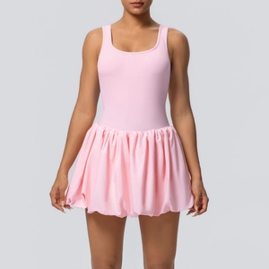 Detail of pink backless tennis dress showing elastic fabric and pleated skirt hem