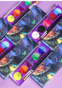 Flat lay of UV neon water soluble body paint kits with brushes on purple background