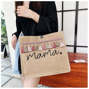 Detailed side view of cotton linen tote bag with mama print and colorful tassel fringes