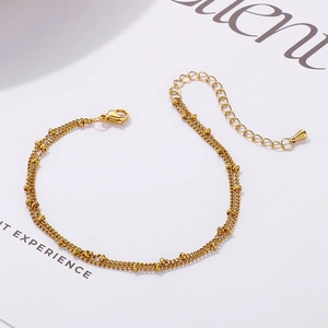 Minimalist double-layer beaded stainless steel bracelet with golden finish and extender